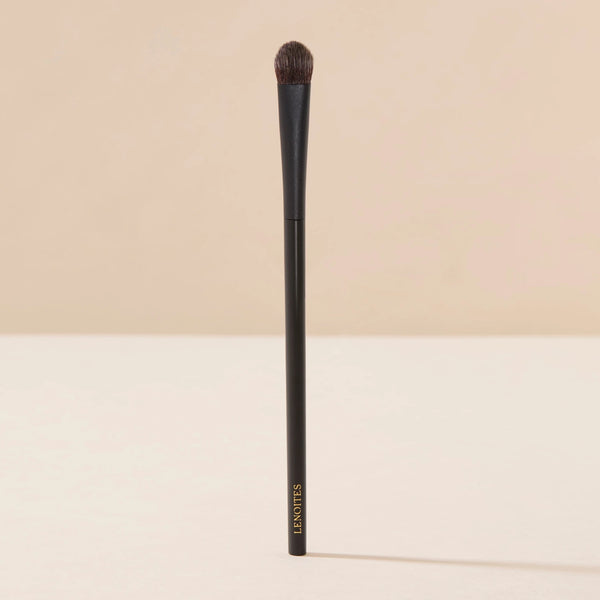 Brush Me Blending Multi Eye Brush No. 134 by Lenoites, featuring a sleek black handle with a soft, rounded brush head, displayed against a soft beige background.