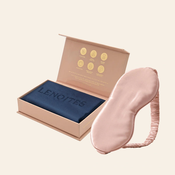 Pillowcase and Sleep Mask in Mulberry Silk by Lenoites featuring a pink silk sleep mask and a blue mulberry silk pillowcase presented in an open blush pink box against a soft light background.