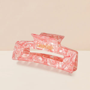 Eco-friendly Hair Claw Medium in Candy Pink by Lenoites, featuring the brand logo in gold, displayed against a soft beige background.