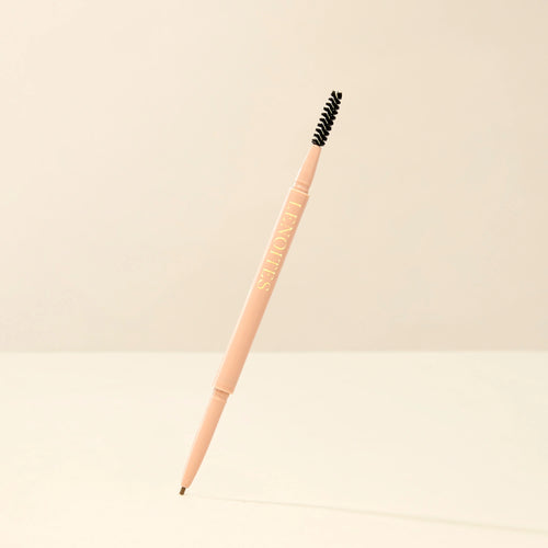 Brow Micro Sculpting Pencil in Light Brown by Lenoites, featuring a dual-ended pencil with a spoolie brush on one end and a fine pencil tip on the other, displayed against a soft beige background.