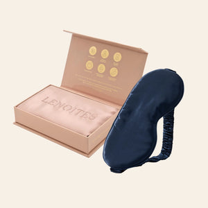 Pillowcase and Sleep Mask in Mulberry Silk by Lenoites featuring a blue silk sleep mask and a pink mulberry silk pillowcase presented in an open blush pink box against a soft light background.
