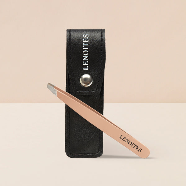 Premium Slant Tweezer by Lenoites, featuring a sleek, angled pink handle with a black protective case, displayed against a soft beige background.