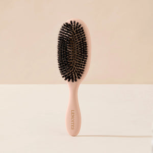 Wild Boar Hair Brush in Blush by Lenoites, featuring a sleek handle and bristles, displayed against a soft beige background.