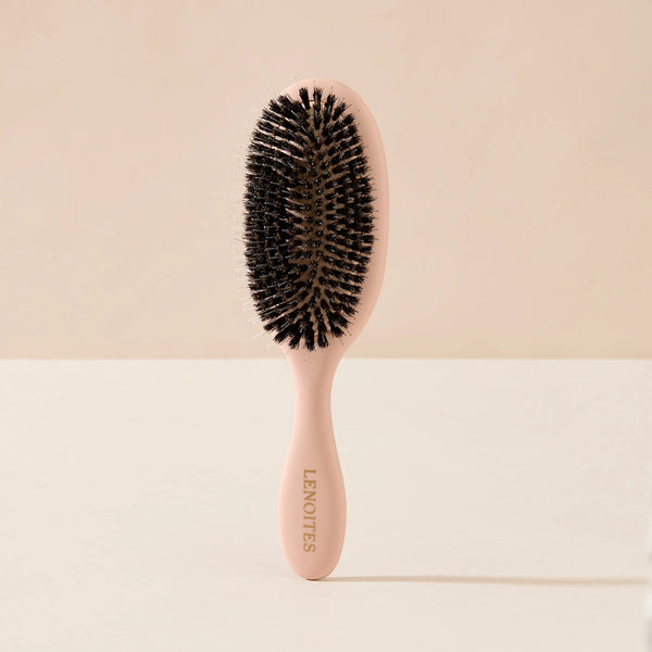 Wild Boar Hair Brush in Blush by Lenoites, featuring a sleek handle and bristles, displayed against a soft beige background.